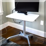 F25. Adjustable computer table. 